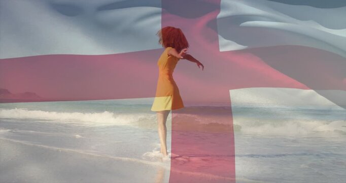 As breeze moving sheer red-cross flag across yellow-dress dancer spinning on surf for health ad