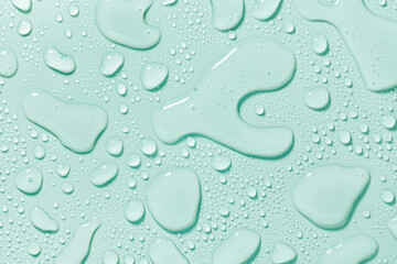 Cosmetic moisturizing liquid drops on grey pastel background. Toner or lotion. Hyaluronic serum or micellar water
