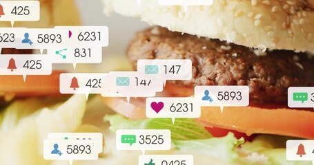 Showing hamburger with sesame bun and beef patty, tomato, lettuce on tabletop, with notifications © vectorfusionart