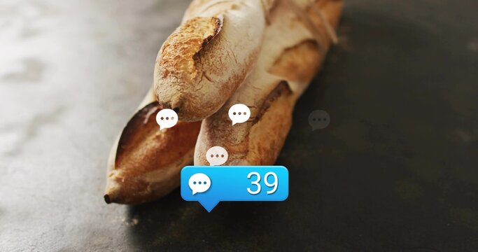 Displaying three crusty baguettes resting on dark countertop, showing white speech bubbles, blue 39