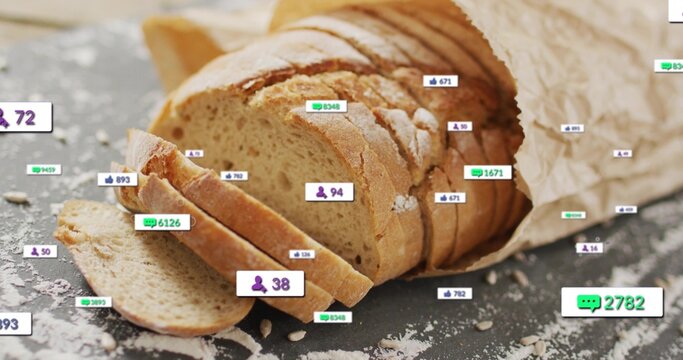 Showing sliced crusty bread fanning on dark slate, with brown paper bag, crumbs, seeds, and badges