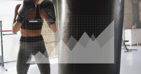 Preparing athlete hitting heavy bag in gym, in sportswear, boxing gloves, data overlay, copy space