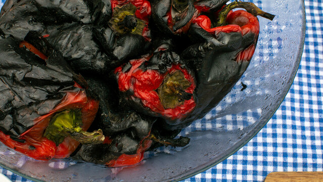 Charred red peppers, rustic picnic tapestry, vibrant harvest feast, smoky beltane celebration, Balkan culinary tradition, autumnal warmth