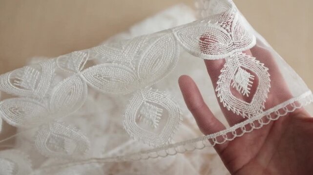 Luxury white Guipure lace fabric featuring intricate geometric and floral embroidery. High-quality bridal textile with raised textures and elegant raftsmanship, perfect for wedding fashion.