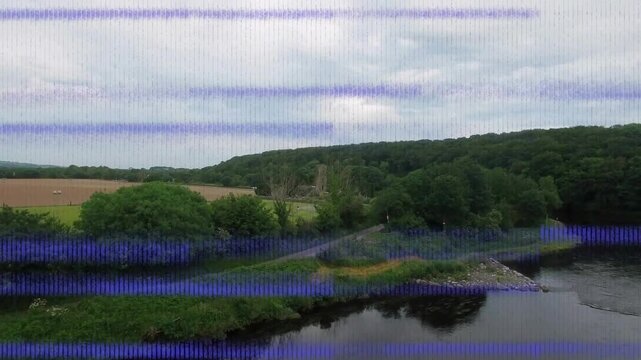 Camera panning right over river and bank, glitch bands appearing obscuring then revealing valley