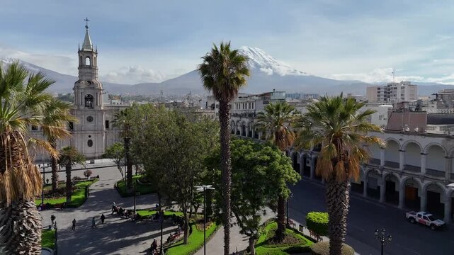 Aerial view of the Plaza de Armas in Arequipa and the Misti volcano with snow during the rainy season
