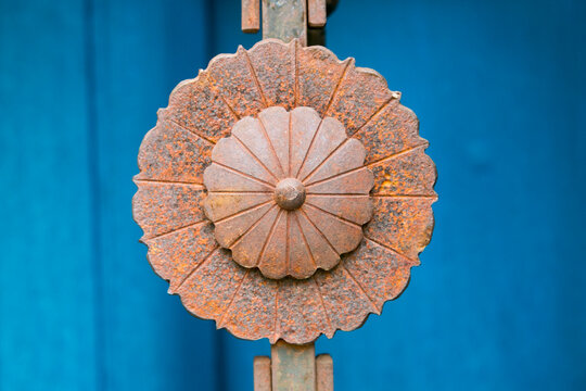 Taos, New Mexico, USA. Rusted metal concha and blue door