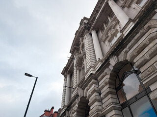 Naklejka premium Historic Manchester, UK building with ornate architecture and a dental clinic sign on the corner