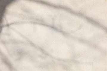 Textured beige background with shadow patterns during daylight