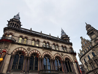 Naklejka premium Historic Manchester Town Hall style building with arches and towers in the city center, United Kingdom