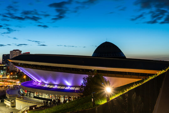 Spodek arena illuminated with purple lights at dusk, 17 October 2024,, Katowice in Poland