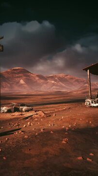 Cinematic dusk over remote outbuilding and rusted relics, dramatic color grading and textured foreground, distant mountains and stormy cloudline create
