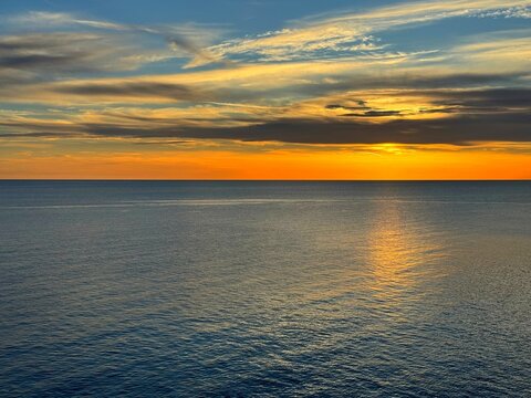Calm sea and dusk sky clouds at evening.