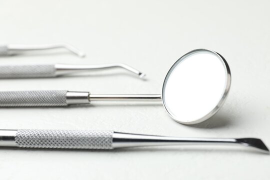 Many different dental tools on white table, closeup