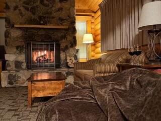 Fototapeta premium Fireplace and furniture in cozy room. Interior design