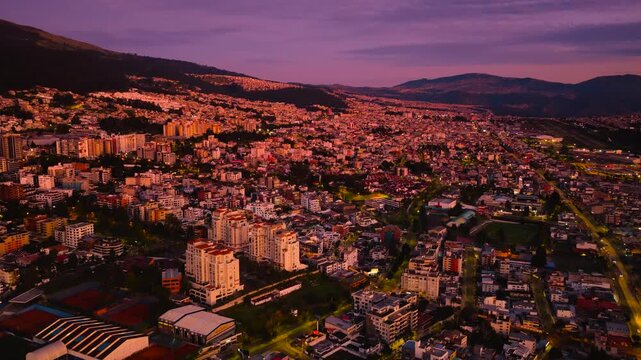 Quito, Ecuador at sunrise with buildings and streets in the foreground