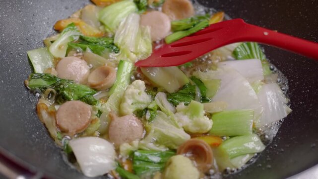 Sprinkle salt on the capcay dish in the pan and stir. Capcay or chop suey (Chinese food) cooking process