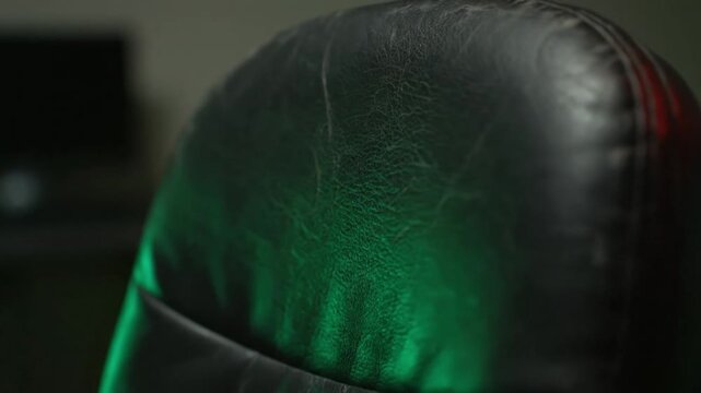 Close-up of Worn Dark Faux Leather Material Exhibiting Fine Creases and Fnt Reddish Scuffs
