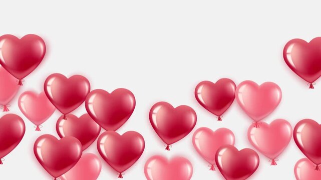 Heart shaped balloons fly up on white background.