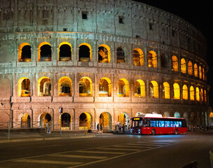 Colosseum at night in Rome, Italy, with red bus © Олеся Матвеева