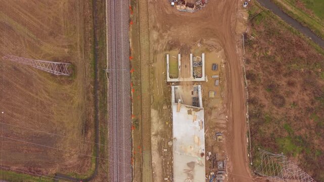 Unfinished Bridge and Road Construction: An aerial view showcases the ongoing construction of a bridge alongside an existing road.