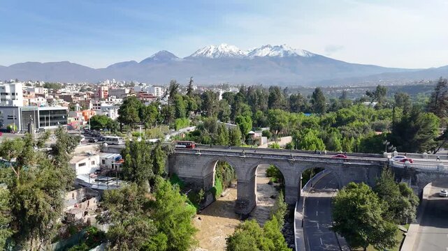 Aerial view of the Grau Bridge, the Chili River, and the Chachani volcano in Arequipa, Peru.