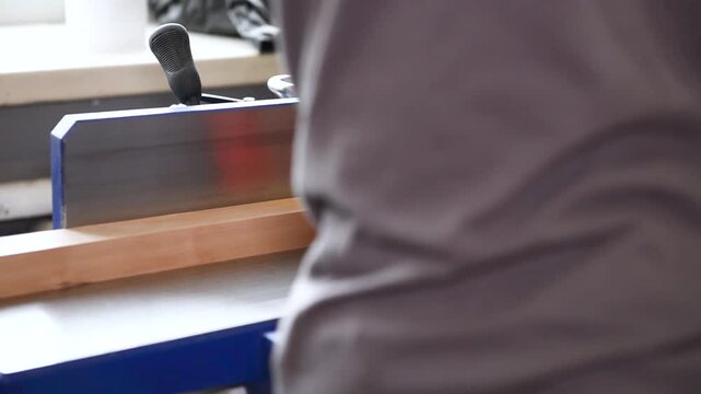 Carpenter operate electric Thickness Planer remove excess wood with. Wood shaping, precision cut, workshop tool, material trim, professional skill, surface smoothing