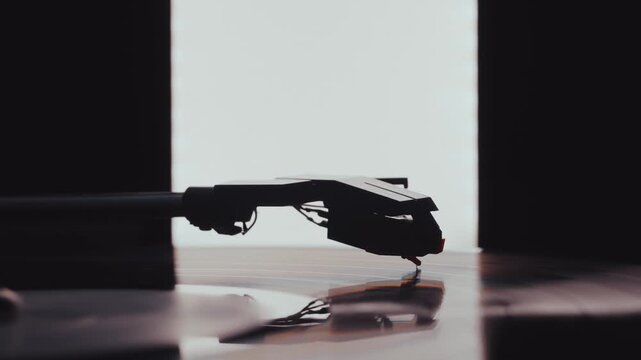 Vinyl record player needle stylus and tonearm playing music