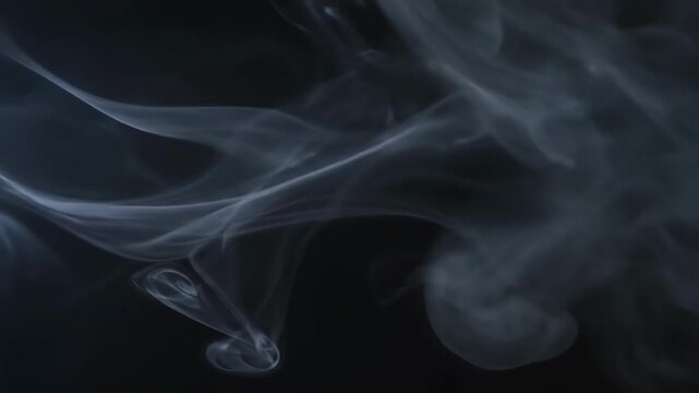 An evocative image of swirling white smoke against a dark background. Ideal for concepts of mystery, transformation, or adding a dramatic effect to de