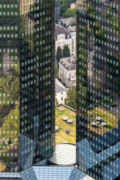 Aerial city view of Frankfurt Germany shows modern office skyscraper architecture rising beside greenery with urban finance character in clear daylight