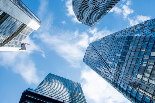 Modern glass skyscraper architecture in Frankfurt Germany with office finance atmosphere and bold perspective against a bright sky above the city