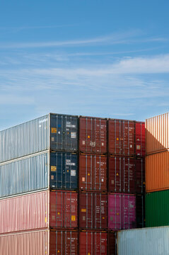 Shipping containers stacked in a busy cargo yard