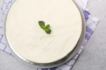 Fotobehang Eten Yummy cheesecake with mint on grey table, top view  © New Africa