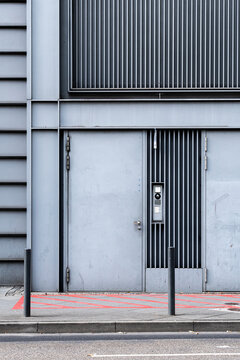 Urban concrete wall with minimal door facade features vertical lines and subtle detail for contemporary architecture entrance and design background