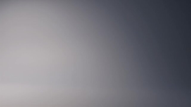 A smooth gradient blends from pale gray to deep blue-gray. The image is a simple, abstract composition