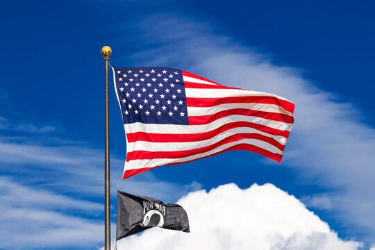 american flag and pow mia flag waving on flagpole in washington dc