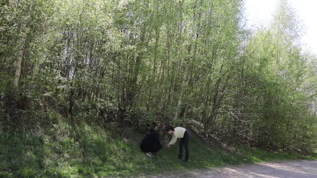 a young couple in love walking through a blooming spring park