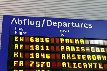 Airport departures board showing flight information for international destinations