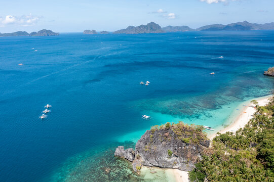 Aerial view of Seven Commandos Beach with limestone cliff separating Papaya Beach in El Nido