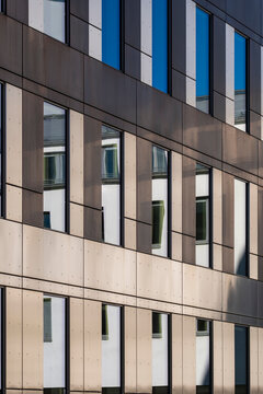 Minimal abstract modern office facade on curved building with windows creating symmetry in architecture detail of clean corporate exterior design