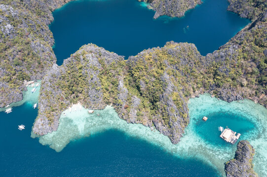 Drone aerial tropical lagoon surrounded by limestone cliffs Coron