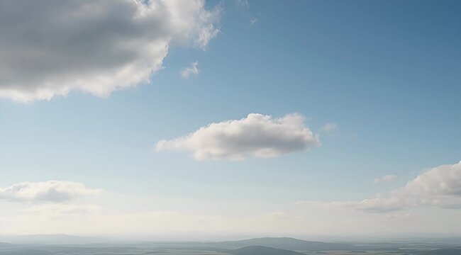 Panoramic vista of a brilliant blue sky adorned with fluffy clouds