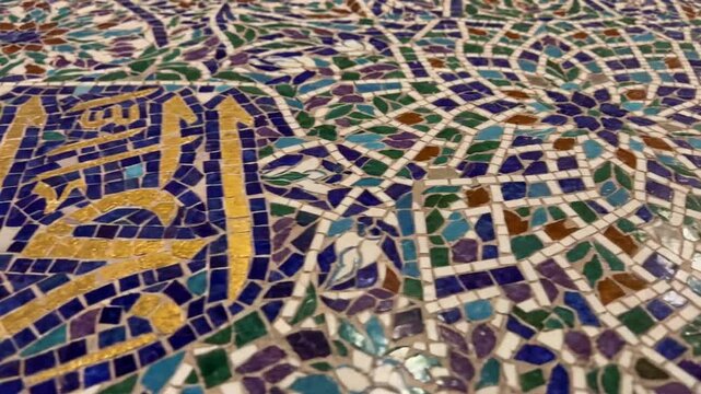 Detailed ancient mosaic tile pattern with colorful ceramic pieces forming a vintage ornamental design