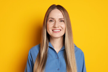 Fototapeta premium Portrait of beautiful woman on yellow background