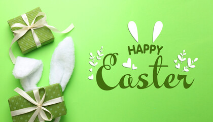 Happy Easter greeting poster with bunny ears headband and gift boxes on green background, top view © New Africa