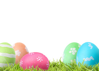 Fototapeta premium Easter eggs in green grass against white background