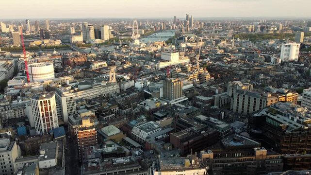 Golden hour illuminates Londons Holborn and Bloomsbury districts, with the River Thames and London Eye visible in the distance.