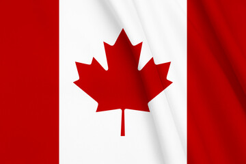 Flag of Canada with maple leaf on fabric as background