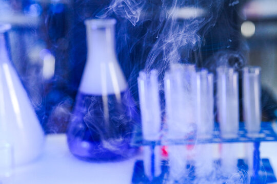 Macro photography of cryogenic vapor sublimation in sterile glass test tubes. Physical chemistry experiment demonstrating extreme thermal phase transition.