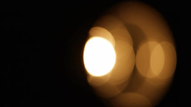 A lone flame glows in the absolute darkness, evoking feelings of hope, resilience, and quiet determination. Ideal for concepts of inner strength or a 